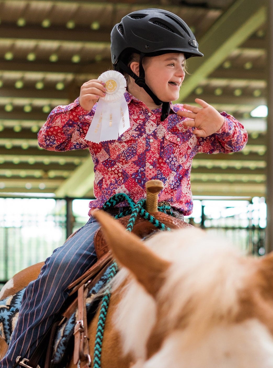 Girl on horseback wins ribbon